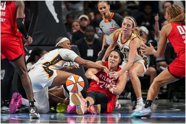 Brionna Jones Fights to get a pass against Fever defenders